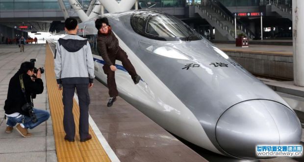 On a high: passengers before boarding a high-speed train on the new 2,298km (1,425-mile) line between Beijing and Guangzhou in China. The line is the latest milestone in the country’s super-fast rail network. photograph: str/afp/getty images